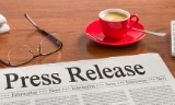 newspaper-on-a-wooden-desk-press-release-picture-id828597350